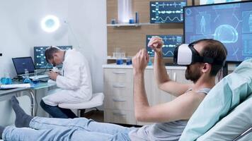 Doctor in a modern neurology centre working on microscope. Patient wearing virtual reality goggles in a neurology facility. video