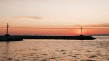 Silhouette of lighthouses on beautifl orange sunset. End of summer vacation. video