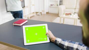 Top down view of green screen digital tablet PC on the table in modern and bright living room video