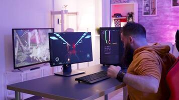 Man preparing to playing an online shooter game tournament sitting on gaming chair. video