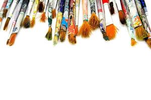 Many colorful paintbrush of artist be stained water or acrylic color isolated on white background and selective focus. Object, Tool and Art concept photo