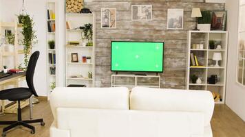 Green screen tv in a bright and well lit living room. Zoom in parallax shot. video