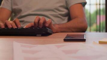 Handheld shot of office worker reaching out at the phone in warm orange sunset light. Slow motion footage video