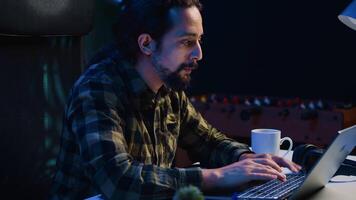 glad man håller på med uppkopplad handla, skriver kreditera kort information på bärbar dator tangentbord på Hem. glad person tillsats betalning metod på hemsida, upphetsad till inköp grejer, kamera en video