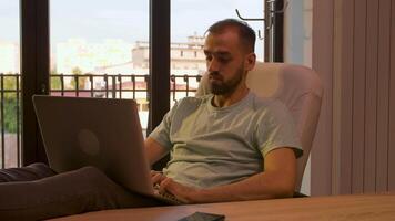 Relaxed manager in his office typing on the laptop. Warm sunset light. Successful businessman. video