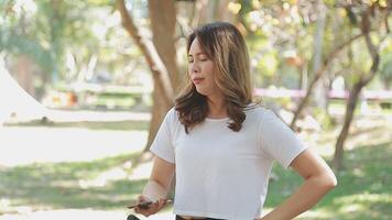 Happy Asian beautiful young woman riding bicycle on street outdoor near building city, Portrait of smiling female lifestyle using bike in summer travel means of transportation, ECO friendly video