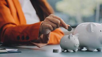 Woman Putting Coin In Piggy Bank, Indoors video