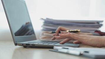 Asian Businesswoman Using laptop computer and working at office with calculator document on desk, doing planning analyzing the financial report, business plan investment, finance analysis concept. video