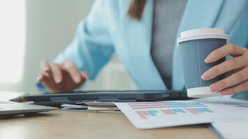 Asian Businesswoman Using laptop computer and working at office with calculator document on desk, doing planning analyzing the financial report, business plan investment, finance analysis concept. video