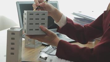 Person Hand Doing Property Tax Calculation Using Calculator Of House Model video