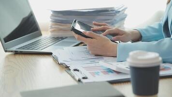 Asian Businesswoman Using laptop computer and working at office with calculator document on desk, doing planning analyzing the financial report, business plan investment, finance analysis concept. video