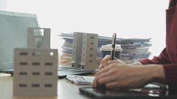 Person Hand Doing Property Tax Calculation Using Calculator Of House Model video