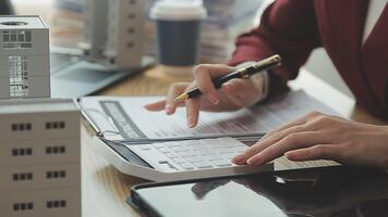 Person Hand Doing Property Tax Calculation Using Calculator Of House Model video