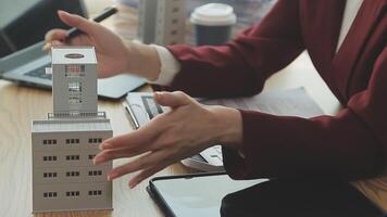 Person Hand Doing Property Tax Calculation Using Calculator Of House Model video