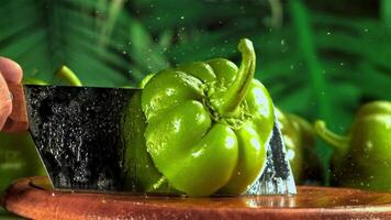 The knife cuts the bell pepper in half. Filmed on a high-speed camera at 1000 fps. High quality FullHD footage video