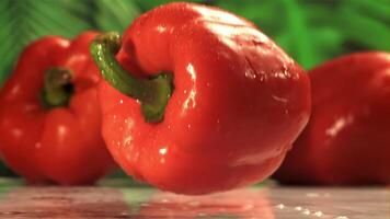 Red bell pepper falls on a wet table. Filmed on a high-speed camera at 1000 fps. High quality FullHD footage video