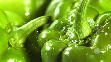 Drops of water fall on sweet peppers. Macro shot. Filmed on a high-speed camera at 1000 fps. High quality FullHD footage video