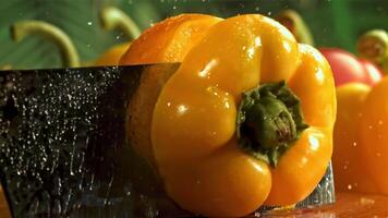 The knife cuts the bell pepper in half. Filmed on a high-speed camera at 1000 fps. High quality FullHD footage video