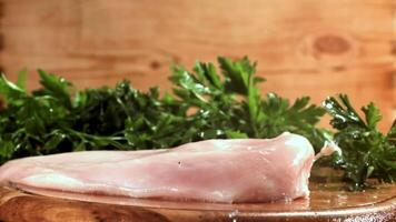 Chicken fillet falling on a cutting board. Filmed on a high-speed camera at 1000 fps. High quality FullHD footage video