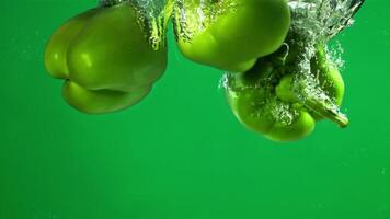 Green sweet pepper falls under water. Filmed on a high-speed camera at 1000 fps. High quality FullHD footage video