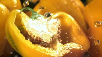 Drops of water fall on a cut sweet pepper. Filmed on a high-speed camera at 1000 fps. High quality FullHD footage video