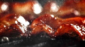 Bacon is fried in a pan. Filmed on a high-speed camera at 1000 fps. High quality FullHD footage video