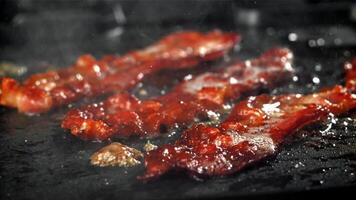 bacon é frito dentro uma frigideira. filmado em uma alta velocidade Câmera às 1000 fps. Alto qualidade fullhd cenas video