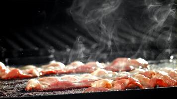 Bacon is fried in a pan. Filmed on a high-speed camera at 1000 fps. High quality FullHD footage video