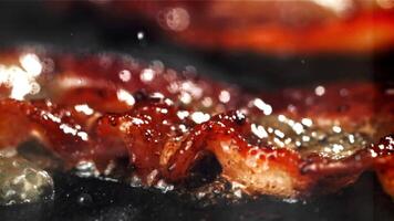 Bacon is fried in a pan. Filmed on a high-speed camera at 1000 fps. High quality FullHD footage video