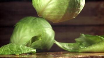 The cabbage falls on the table. Filmed on a high-speed camera at 1000 fps. High quality FullHD footage video