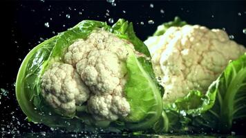 Raindrops fall on cauliflower. Filmed on a high-speed camera at 1000 fps. High quality FullHD footage video