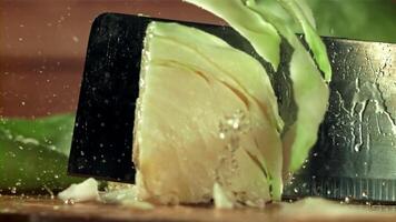 The cook cuts the cabbage with a knife. Filmed on a high-speed camera at 1000 fps. High quality FullHD footage video