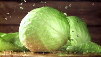 Drops of water fall on the cabbage. Filmed on a high-speed camera at 1000 fps. High quality FullHD footage video