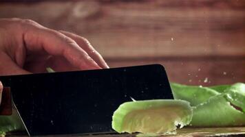 The cook cuts the cabbage with a knife. Filmed on a high-speed camera at 1000 fps. High quality FullHD footage video