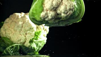 Falling cauliflower with splashing water. Filmed on a high-speed camera at 1000 fps. High quality FullHD footage video