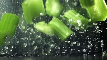 The knife cuts through the fresh sprinkled celery. Filmed on a high-speed camera at 1000 fps. High quality FullHD footage video