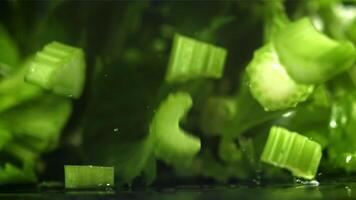 Pieces of chopped celery fall on the table. Filmed on a high-speed camera at 1000 fps. High quality FullHD footage video