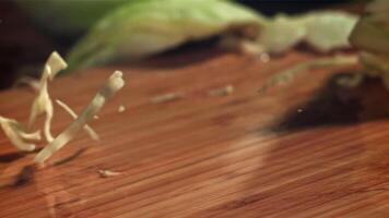 The shredded cabbage falls onto the cutting board. Filmed on a high-speed camera at 1000 fps. High quality FullHD footage video