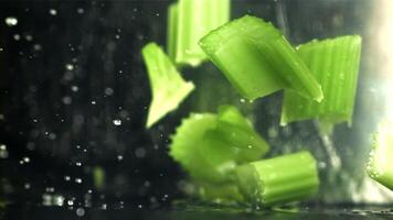 The knife cuts through the fresh sprinkled celery. Filmed on a high-speed camera at 1000 fps. High quality FullHD footage video