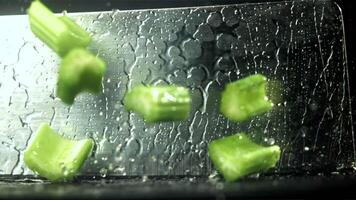 The knife cuts through the fresh sprinkled celery. Filmed on a high-speed camera at 1000 fps. High quality FullHD footage video