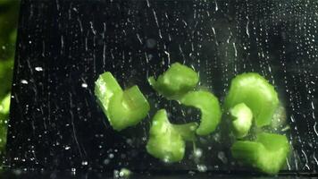 The knife cuts through the fresh sprinkled celery. Filmed on a high-speed camera at 1000 fps. High quality FullHD footage video