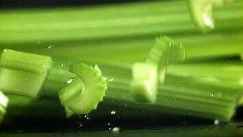 Pieces of chopped celery fall on the table. Filmed on a high-speed camera at 1000 fps. High quality FullHD footage video