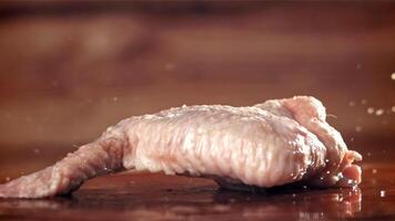 Chicken wings fall on a cutting board. Filmed on a high-speed camera at 1000 fps. High quality FullHD footage video