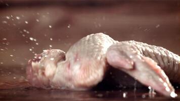 Chicken wings fall on a cutting board. Filmed on a high-speed camera at 1000 fps. High quality FullHD footage video