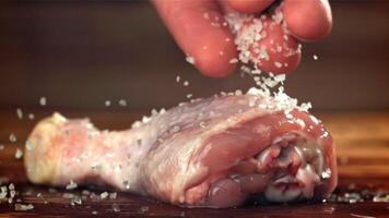 Sprinkle salt on the chicken leg. Filmed on a high-speed camera at 1000 fps. High quality FullHD footage video