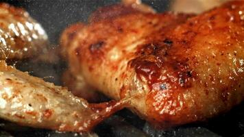 Chicken wings are fried in a pan. Filmed on a high-speed camera at 1000 fps. High quality FullHD footage video