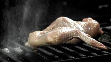 The chicken wing falls into the pan. Filmed on a high-speed camera at 1000 fps. High quality FullHD footage video