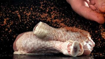 Spices falling on chicken legs. Filmed on a high-speed camera at 1000 fps. High quality FullHD footage video