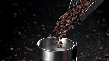 The coffee beans fall into the working grinder. Filmed on a high-speed camera at 1000 fps. High quality FullHD footage video