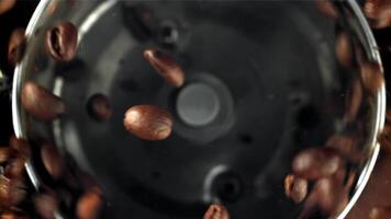 Coffee beans in a working grinder. Filmed on a high-speed camera at 1000 fps. High quality FullHD footage video